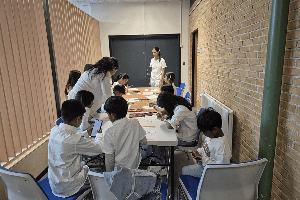 Children sitting in groups during the weekly Dhamma school class